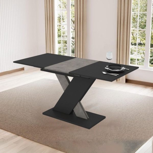 Tavolo allungabile Axi in colore nero con dettaglio gamba e allunga in cemento